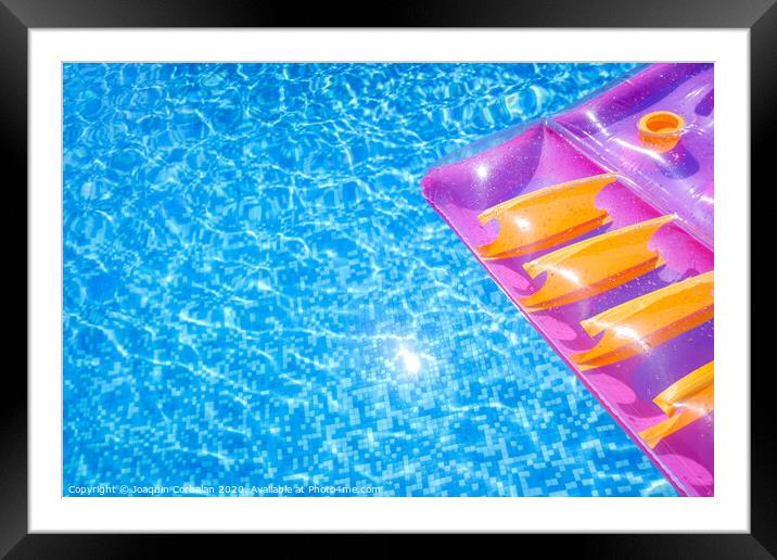 Transparent water from a pool, background with summer colored floats. Framed Mounted Print by Joaquin Corbalan