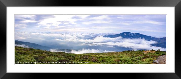 Panoramic image of the views of the Sierra de Guadarrama with its clouds from the top of a mountain peak. Framed Mounted Print by Joaquin Corbalan