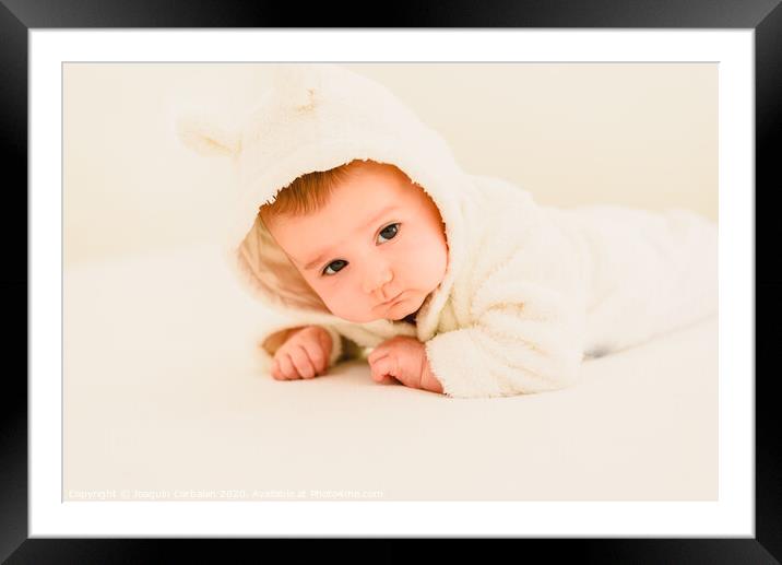 Newborn blonde baby 3 months old lying on her stomach and head raised Framed Mounted Print by Joaquin Corbalan