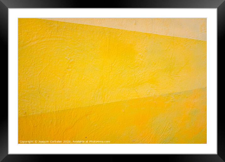 A wall painted with lines of various colors, yellow and orange tones. Framed Mounted Print by Joaquin Corbalan
