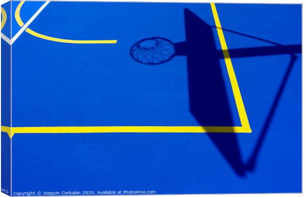 Shadow of a basketball basket on the floor of the court, painted blue and background with lines. Canvas Print by Joaquin Corbalan