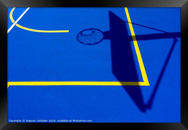 Shadow of a basketball basket on the floor of the court, painted blue and background with lines. Framed Print by Joaquin Corbalan