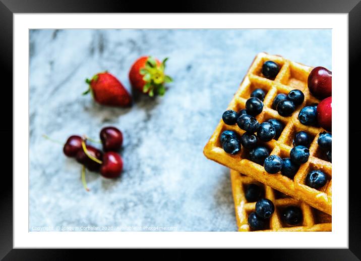 Close-up of a waffle with blueberries and strawberries with delicious aspect, isolated on abstract background with copy space for text. Framed Mounted Print by Joaquin Corbalan