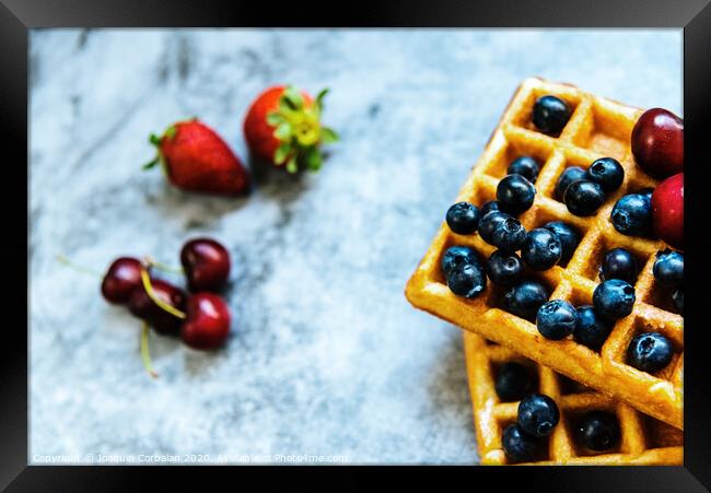 Close-up of a waffle with blueberries and strawberries with delicious aspect, isolated on abstract background with copy space for text. Framed Print by Joaquin Corbalan