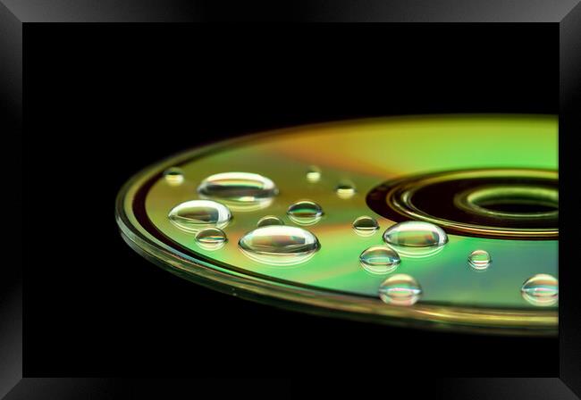CD with water droplets Framed Print by Beata Aldridge