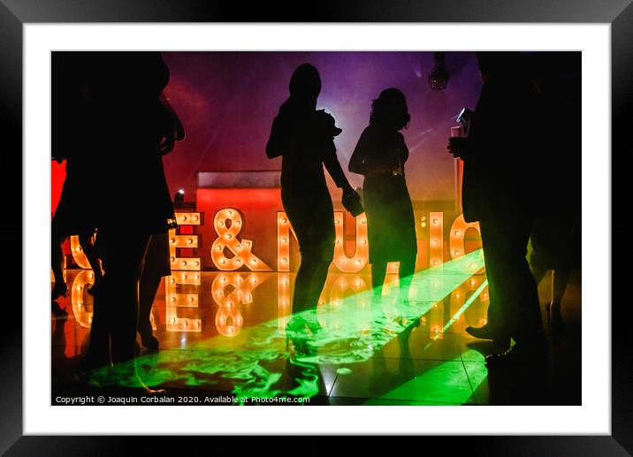 Young people dancing in night club Framed Mounted Print by Joaquin Corbalan