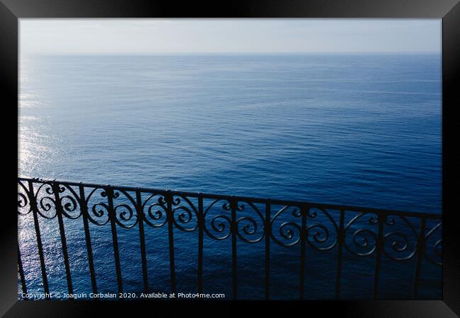 Calm blue sea without waves seen from a cliff with room for text Framed Print by Joaquin Corbalan