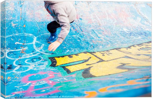 Boy running inside an urban skatepark with sweatshirt having fun, blue tones. Canvas Print by Joaquin Corbalan