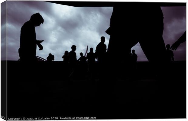 Silhouette of a group of unrecognizable people using their smartphones, socially isolated. Canvas Print by Joaquin Corbalan