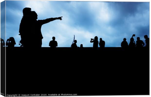 Silhouette of unrecognizable people pointing with a dark background. Canvas Print by Joaquin Corbalan