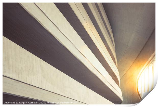 Warm tones background of the interior of a minimalist construction of rough textured walls and lines, illuminated with a sunbeam at sunset. Print by Joaquin Corbalan