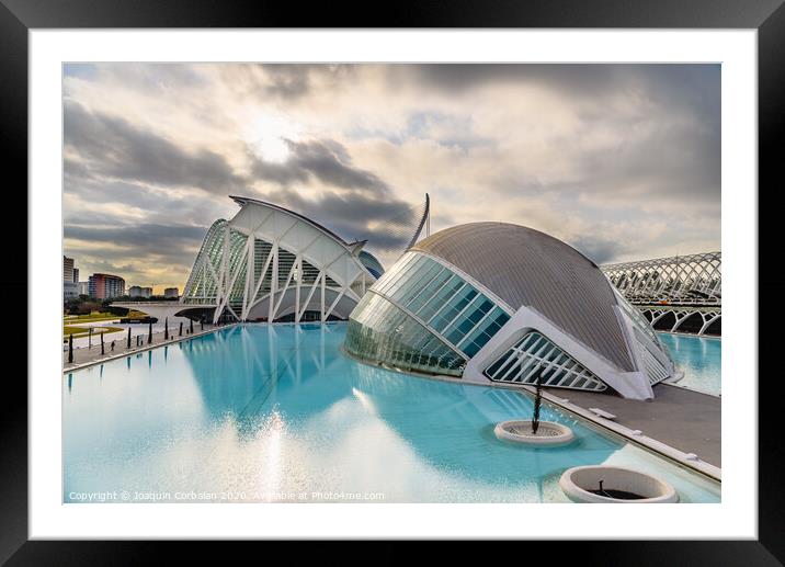 Panoramic cinema in the city of sciences of Valencia, Spain, visited by tourists next to the museum of sciences of the city in the background, at dawn with clouds and sun. Framed Mounted Print by Joaquin Corbalan
