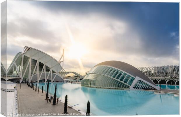 Panoramic cinema in the city of sciences of Valencia, Spain, visited by tourists next to the museum of sciences of the city in the background, at dawn with clouds and sun. Canvas Print by Joaquin Corbalan