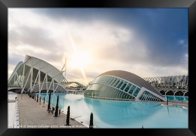 Panoramic cinema in the city of sciences of Valencia, Spain, visited by tourists next to the museum of sciences of the city in the background, at dawn with clouds and sun. Framed Print by Joaquin Corbalan