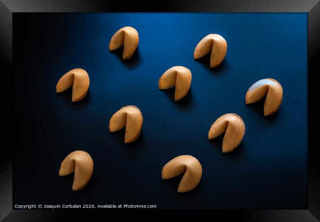 Fortune cookies on dark background arranged symmetrically Framed Print by Joaquin Corbalan