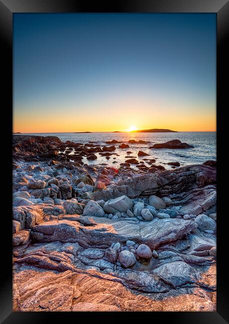 Sunset over the rocky beach at Mealista  Framed Print by Helen Hotson