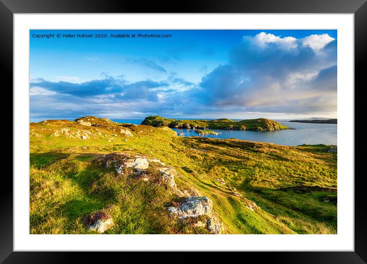Evening light over the grassy coastline at Rodel Framed Mounted Print by Helen Hotson
