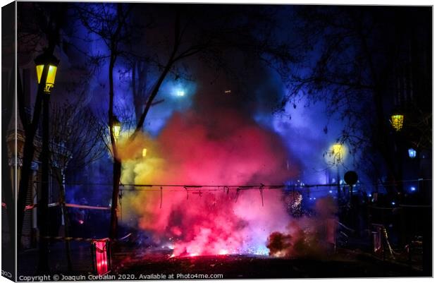 Colorful mascleta full of firecrackers and fireworks with lots of smoke and sparks. Canvas Print by Joaquin Corbalan
