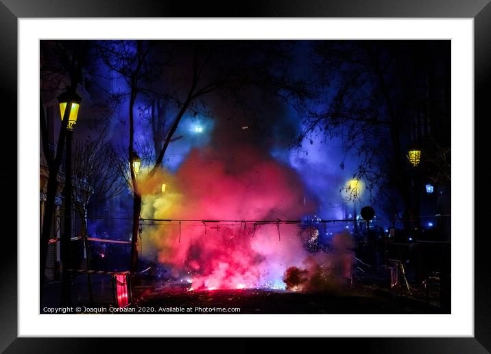 Colorful mascleta full of firecrackers and fireworks with lots of smoke and sparks. Framed Mounted Print by Joaquin Corbalan