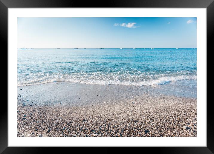 Pebble beach in Condofuri Calabria Italy with fishing boats on the horizon Framed Mounted Print by Natalia Macheda