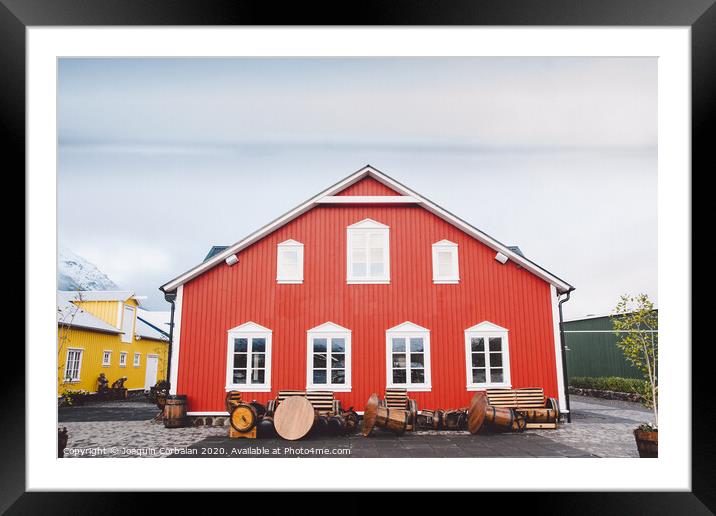 Nice house with red wooden planks in iceland. Framed Mounted Print by Joaquin Corbalan
