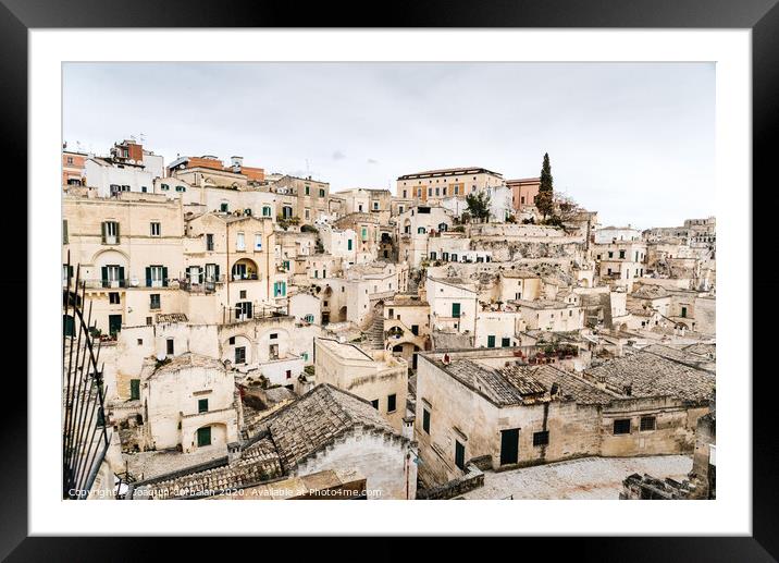 Long panoramic views of the rocky old town of Matera with its stone roofs. Framed Mounted Print by Joaquin Corbalan