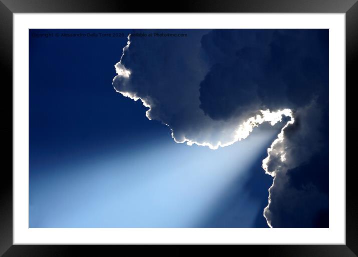 Sunlight rays coming out from clouds Framed Mounted Print by Alessandro Della Torre