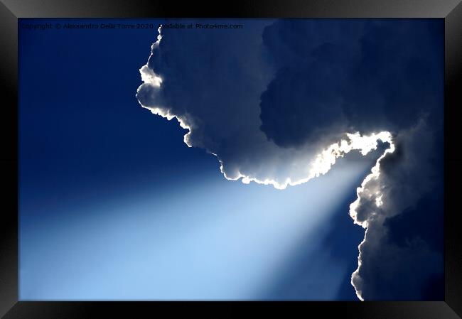 Sunlight rays coming out from clouds Framed Print by Alessandro Della Torre