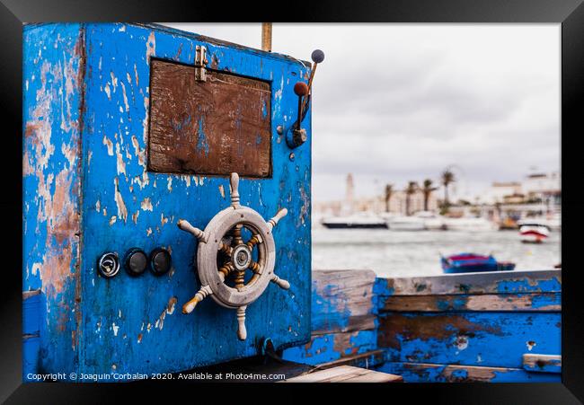 Small wooden rudder of a beached boat aged and abandoned on the shore of the sea. Framed Print by Joaquin Corbalan