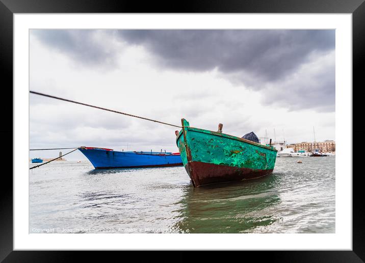 Small boat moored to Bari port, Italy, during a storm at sea. Framed Mounted Print by Joaquin Corbalan