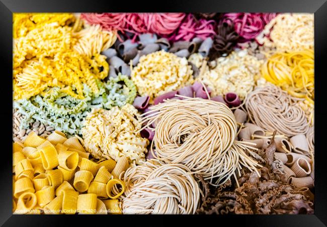 Many types of uncooked Italian pasta of various colors and shapes Framed Print by Joaquin Corbalan
