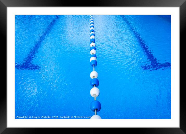 Detail of the water of a pool with beacons to separate the swimming streets. Framed Mounted Print by Joaquin Corbalan