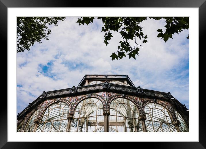 Windows of the glass palace of the Retiro Park in Madrid, with a background of a sky with clouds. Framed Mounted Print by Joaquin Corbalan