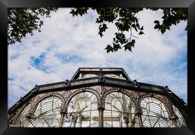 Windows of the glass palace of the Retiro Park in Madrid, with a background of a sky with clouds. Framed Print by Joaquin Corbalan