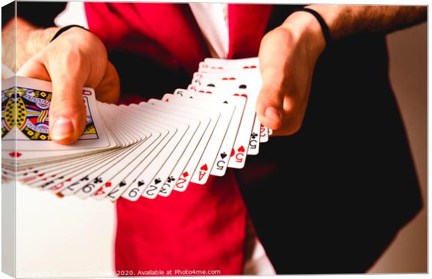 Hands of magician doing tricks with a deck of cards. Canvas Print by Joaquin Corbalan