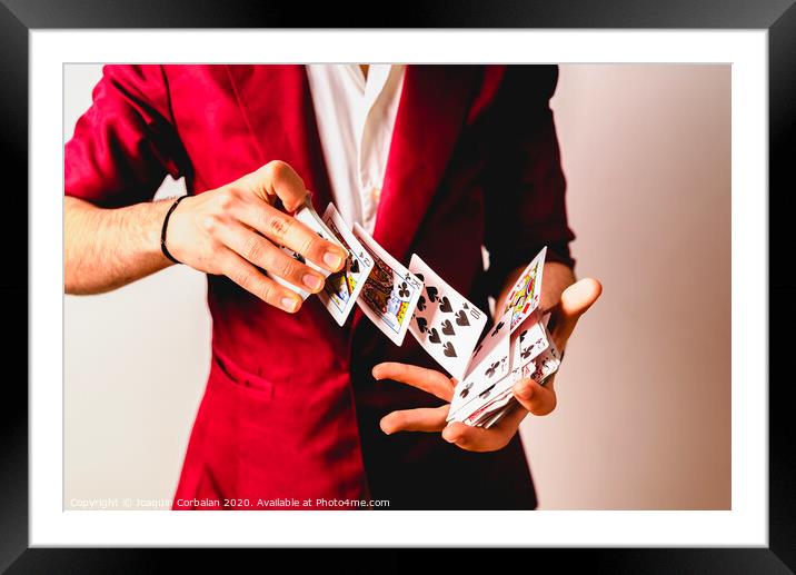 Hands of magician doing tricks with a deck of cards. Framed Mounted Print by Joaquin Corbalan