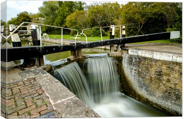 Overflowing lock gates at Stoke Brurne. Canvas Print by Clive Wells