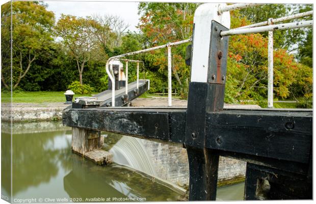 Overflowing lock gates. Canvas Print by Clive Wells
