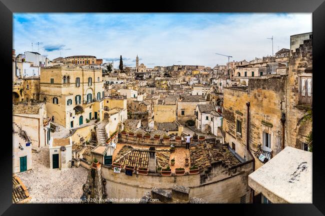 Long panoramic views of the rocky old town of Matera with its stone roofs. Framed Print by Joaquin Corbalan