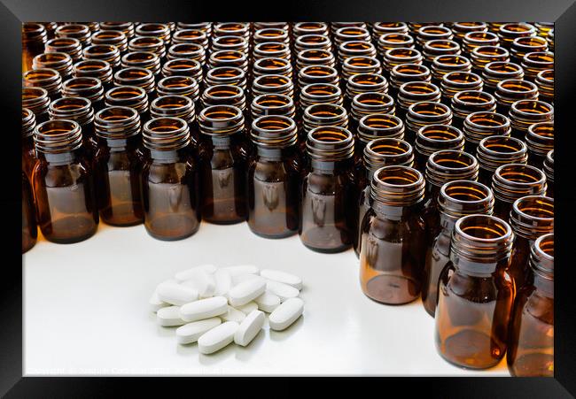 Heap of pills with empty medicine containers, pharmaceutical industry concept. Framed Print by Joaquin Corbalan