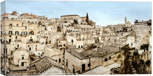 Panoramic view of Matera (Sassi di Matera) with its steep ancient stone streets, European Capital of Culture 2019, with clouds, at southern Italy, waiting to welcome tourists. Canvas Print by Joaquin Corbalan