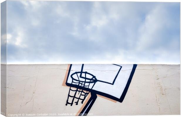 Outdoor basketball court decorated with street graffiti, half with blue sky and clouds in the background. Canvas Print by Joaquin Corbalan