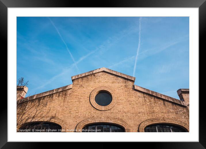 Facade of the old train workshop factories in the Central Park of Valencia. Framed Mounted Print by Joaquin Corbalan
