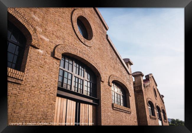 Facade of the old train workshop factories in the Central Park of Valencia. Framed Print by Joaquin Corbalan