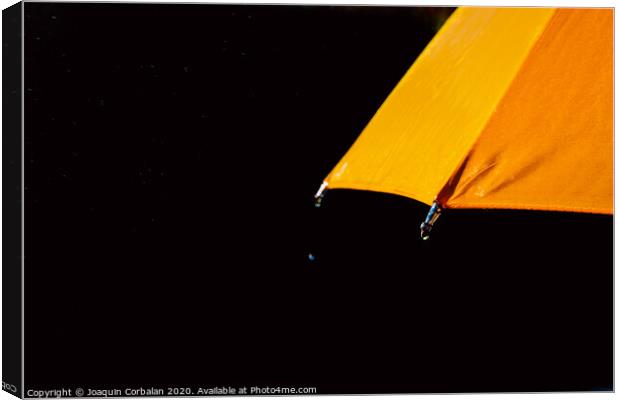 Multicolored umbrella under raindrops isolated on black as background. Canvas Print by Joaquin Corbalan