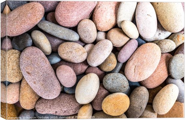 Round beach rocks to decorate the home. Canvas Print by Joaquin Corbalan