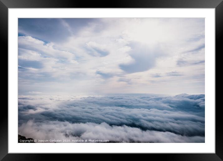 Awesome view on top of the clouds on a cloudy morning. Framed Mounted Print by Joaquin Corbalan