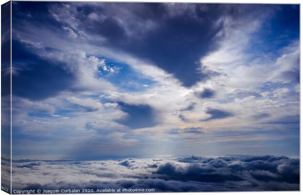 Scene of a winter cloudy sky from the top of a mountain peak. Canvas Print by Joaquin Corbalan