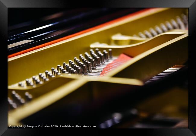 Detail of the interior of a piano with the soundboard, strings and pins. Framed Print by Joaquin Corbalan