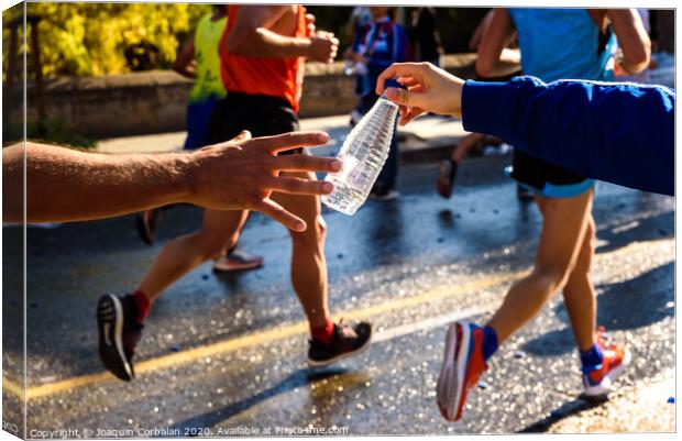 Runner collects a bottle of water to hydrate during a workout. Canvas Print by Joaquin Corbalan